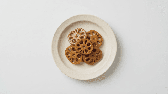 Braised lotus root served on white plate