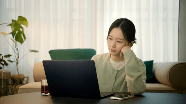 Woman working on a laptop at home