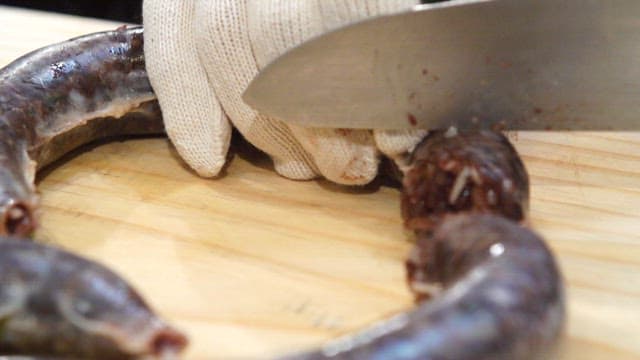 Sundae being sliced on a wooden board