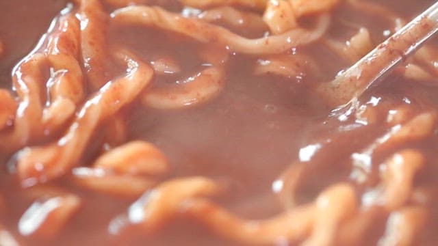 Spoonful of thick, warm red bean noodle soup