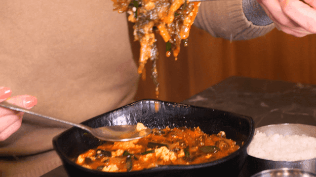 Woman eating soft tofu jjambbong