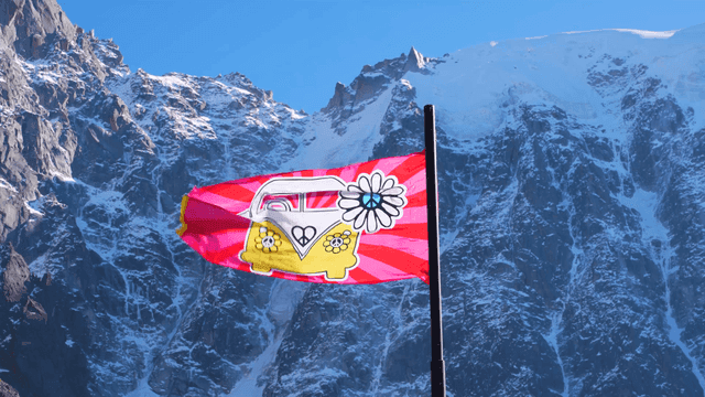 Colorful flag waving in front of snowy mountains