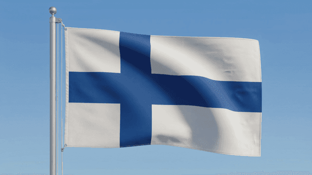 Finnish flag fluttering under clear sky