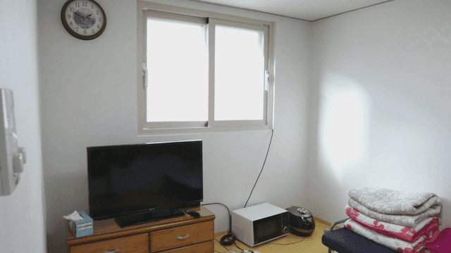 Simple room with a window and clock