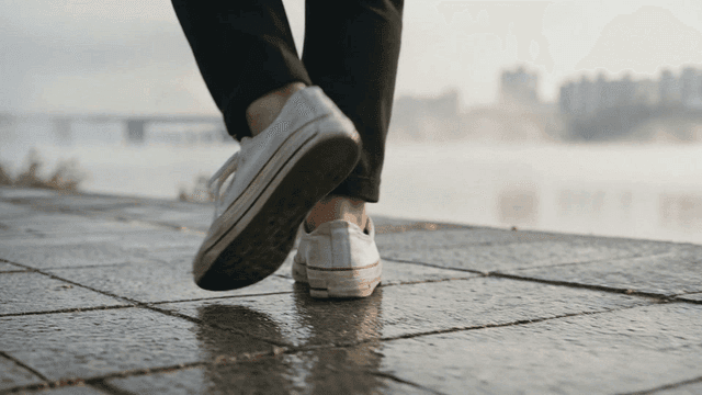 Walking along a wet riverside path