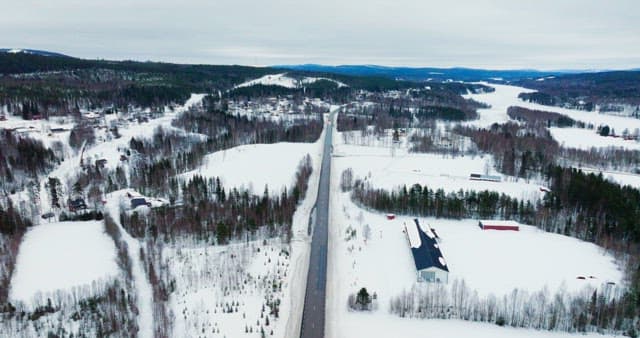 Snow-covered landscape with a road