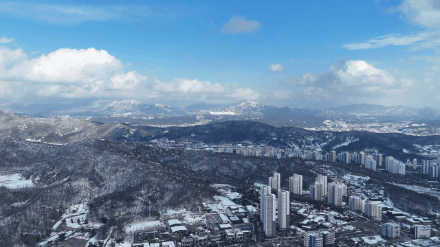 Snow-covered cityscape with mountains