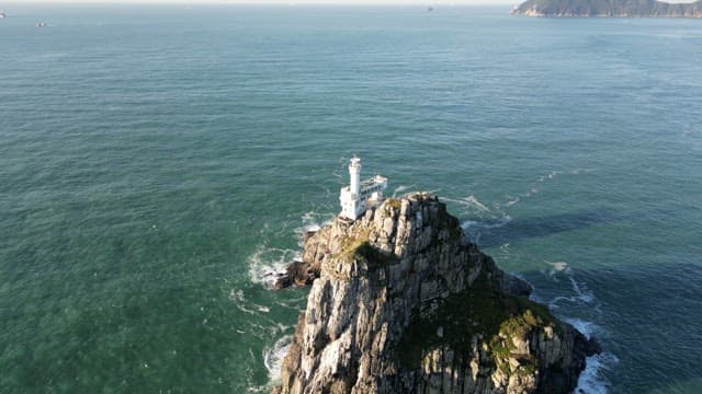 Lighthouse on a rocky island in the sea