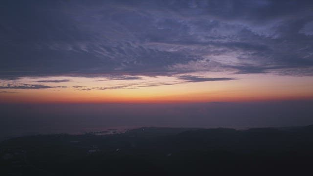 Sunset over a calm coastal landscape