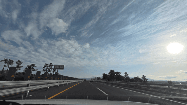 Cars driving on highway under clear sky