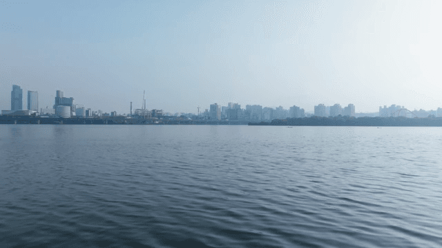 Calm river with a city skyline