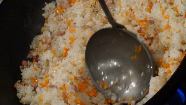 Fried rice being stirred in a pan