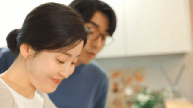 Woman slicing cucumber in a cozy kitchen