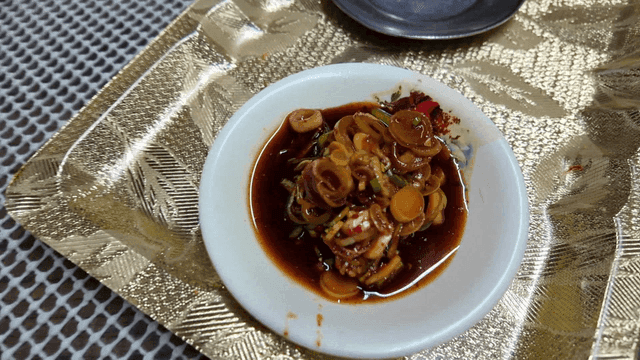 Bowl of soy sauce with chopped green onions
