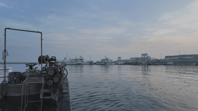 Fishing boats in quiet harbor at dawn