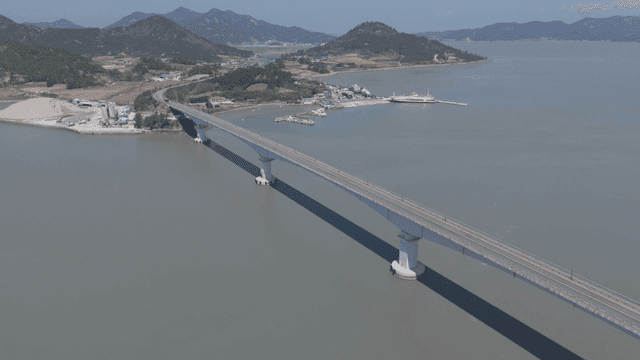 Long bridge over calm river