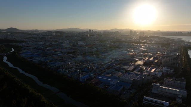 건물과 공장이 빽빽한 산업단지의 일몰