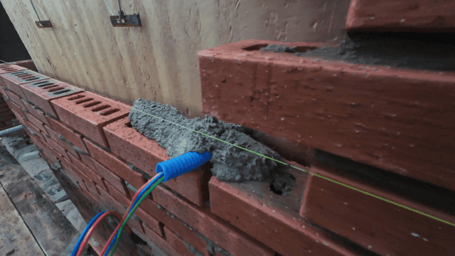 Brick wall construction with mortar