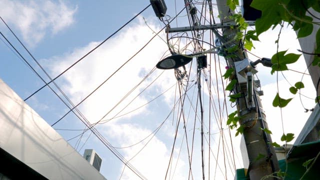 Complex electrical wires under clear skies