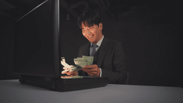 Man pleased by the cash inside a briefcase