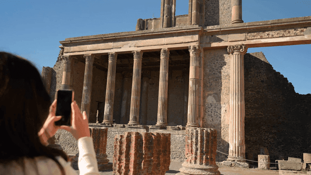 Ancient ruins with tourists taking photos