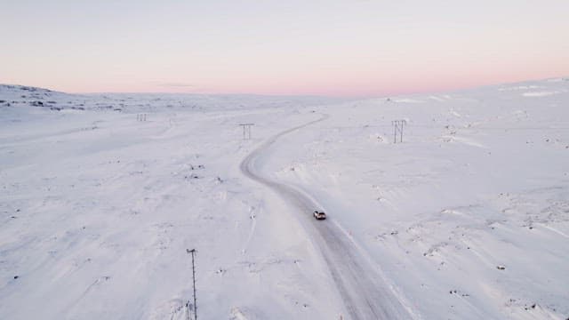 Car driving on a snowy mountain road