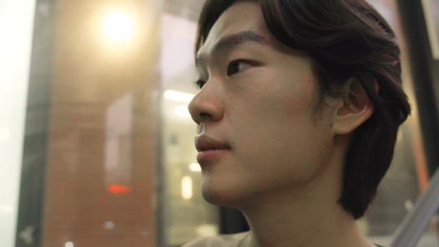 Man looking around on an escalator