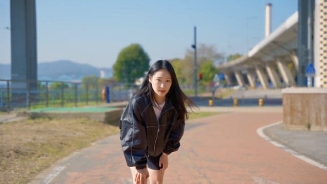 Woman preparing to run on a sunny day