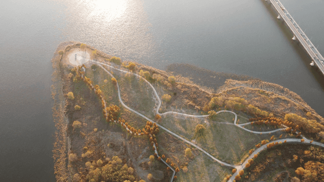 Lakeside park with winding paths.