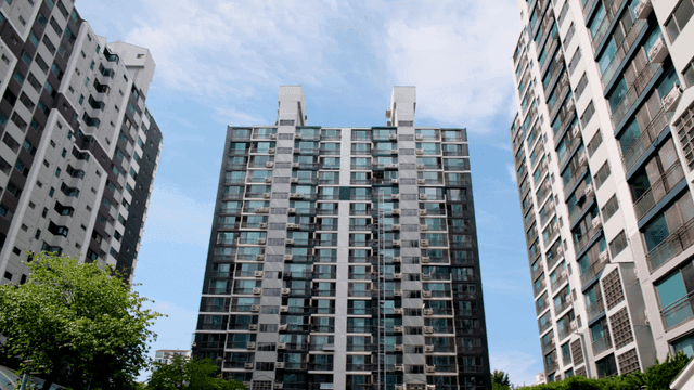 Tall apartment buildings under a clear sky