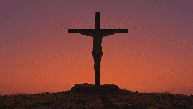 Silhouette of Jesus on cross at sunset
