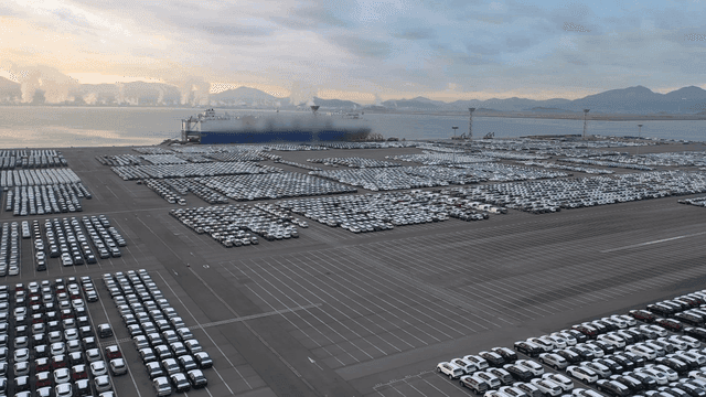 Large loading dock near port filled with cars