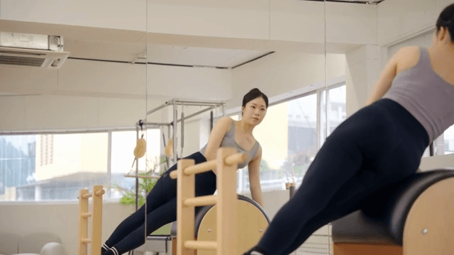 Woman exercising on a pilates barrel