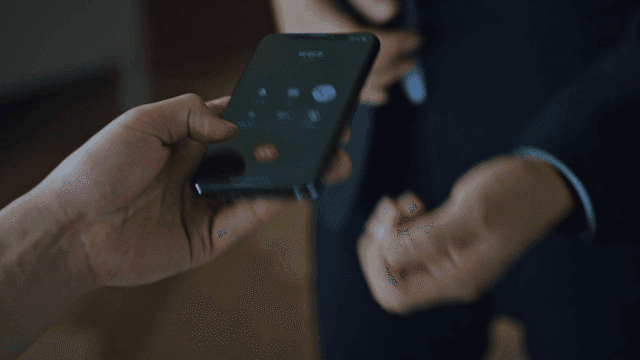 People handing and receiving a ringing phone