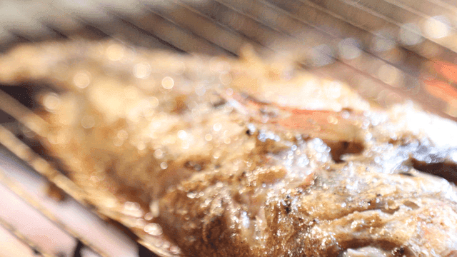 Grilled rockfish sizzling on barbecue