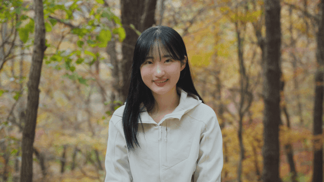 Young woman smiling in autumn forest