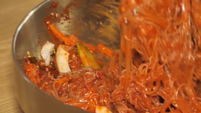 Mixing Spicy Cold Noodles with Chopsticks