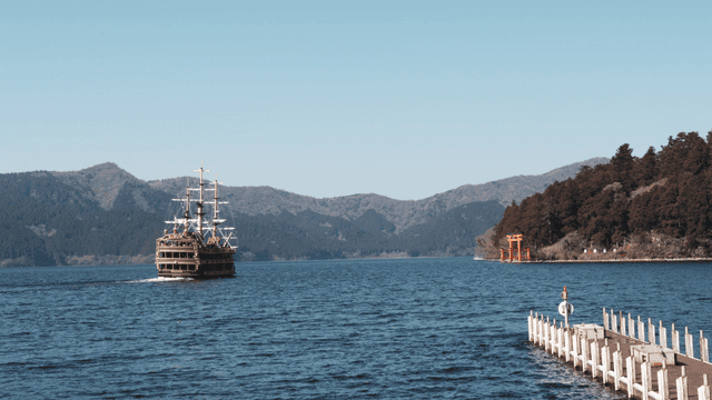 Ship sailing in sea where mountains are visible