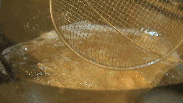 Shrimp being deep-fried in hot oil