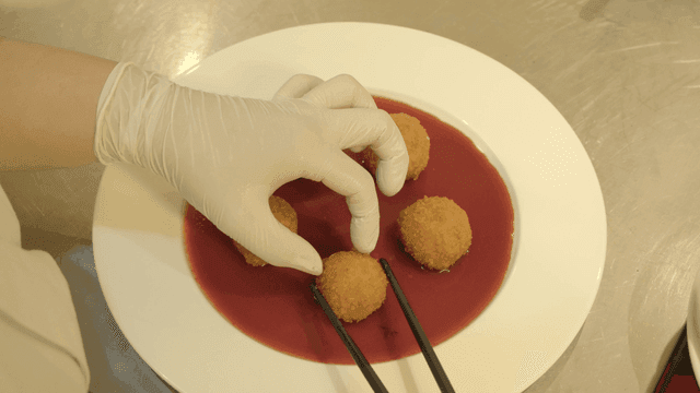 Dish with croquettes in red sauce