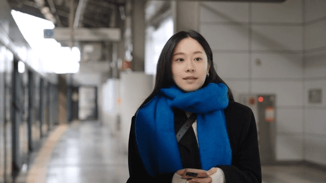 Woman waiting and moving at a subway station