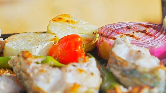 Fresh parrotfish and colorful vegetables grilled on an barbecue grill