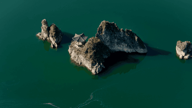 바위 섬 위의 전통 정자가 있는 호수