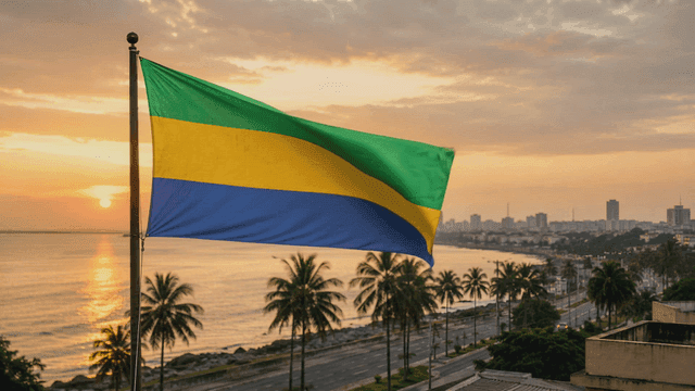 Gabonese flag fluttering on seashore at sunset
