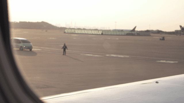 View of the airport runway from an airplane