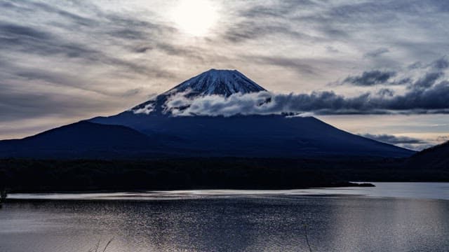 Majestic Mount Fuji with clouds and a lake