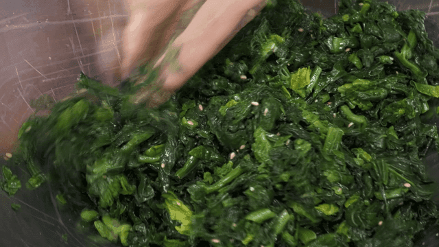 Seasoned spinach in metal bowl