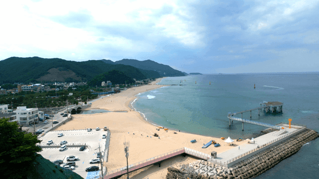 Scenic beach with mountains and a pier