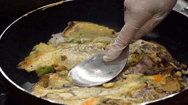 Pan-fried battered pollack pressed with a spatula