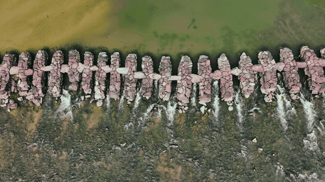 초록색의 강물을 따라 이어진 돌다리의 항공 전경